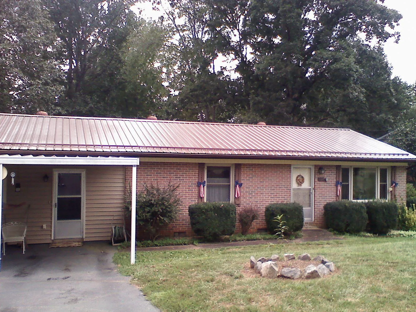 Bronze metal roof and carport on a brick ranch home — Roof Repair work by our crew in Hunt Valley