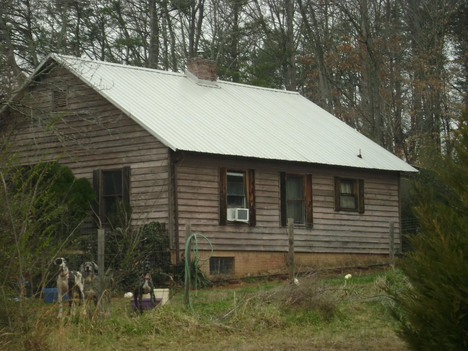 White metal roof on an old wood sided farmhouse, from a Metal Roof Installation job in Hunt Valley